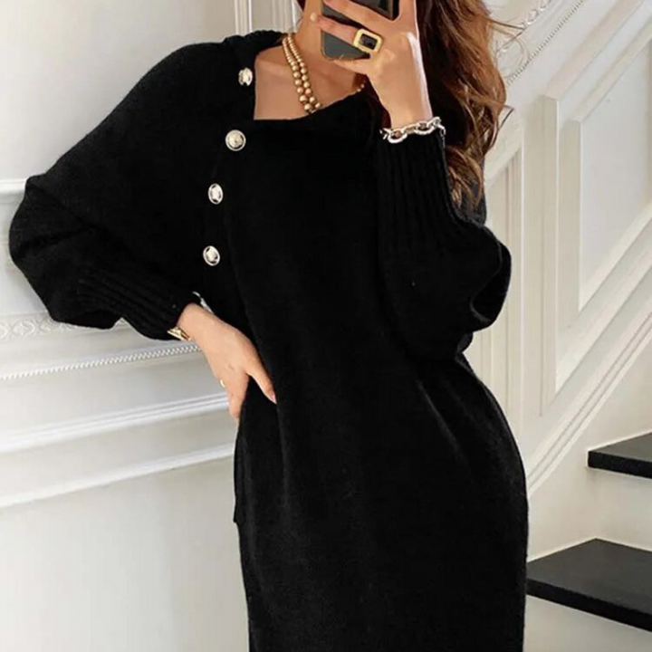 Woman in the Diana cosy wrap dress with gold-tone buttons and a waist tie, holding a warm drink at home.