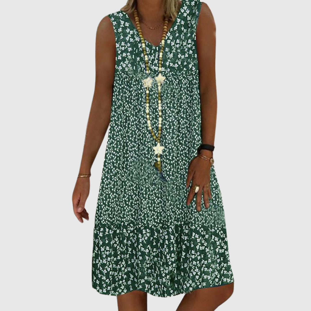 A woman wearing the Wendy sleeveless V-neck floral dress on a sunny day outdoors.