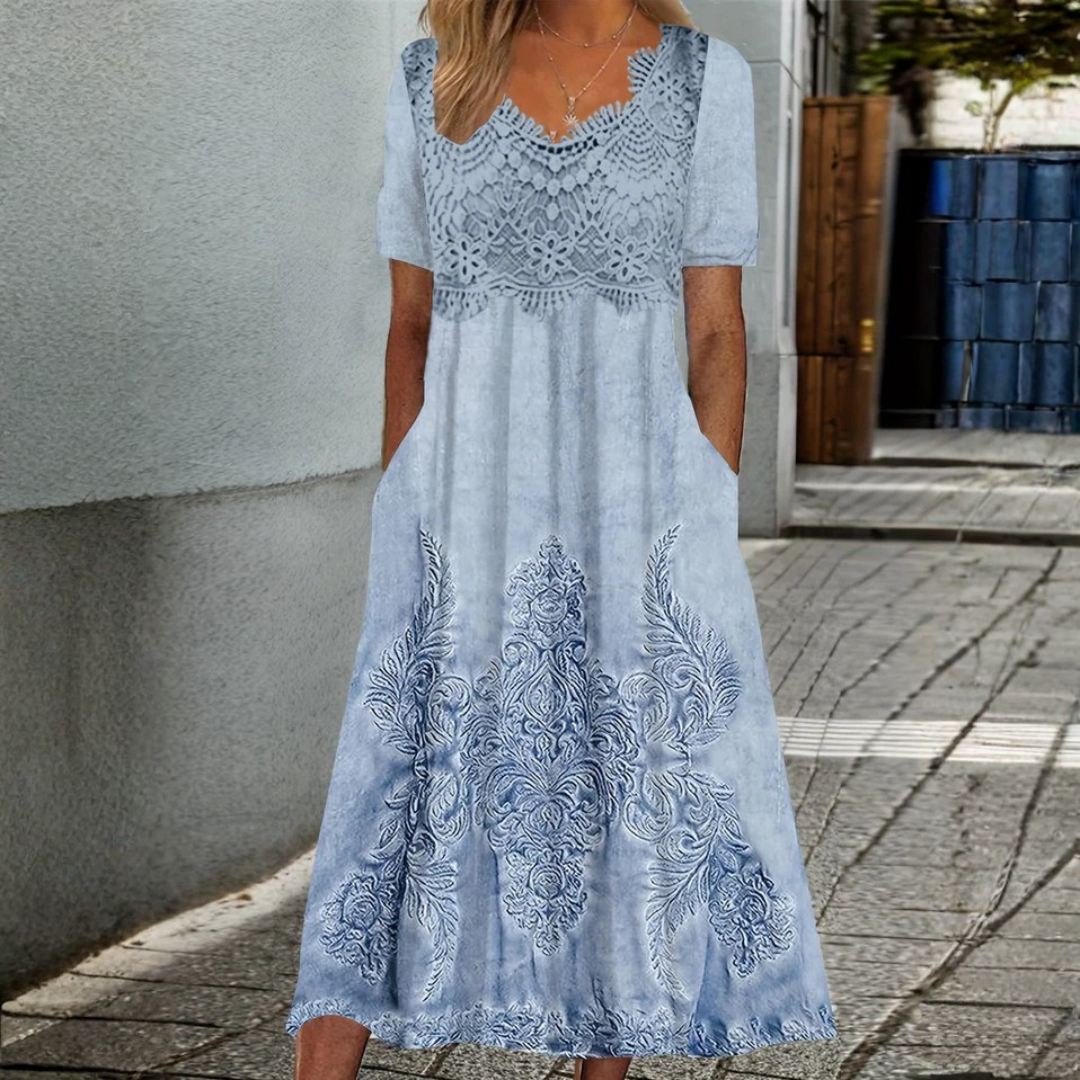 Woman wearing the Catherine soft floral midi dress at a garden gathering.