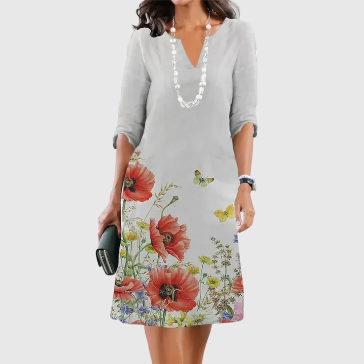 Woman wearing the Carolyn floral A-line dress in ivory, dressed for a daytime lunch.