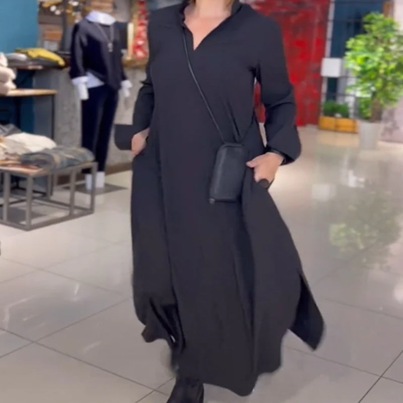 Woman wearing the Patricia relaxed maxi dress with revere collar, standing by a doorway.