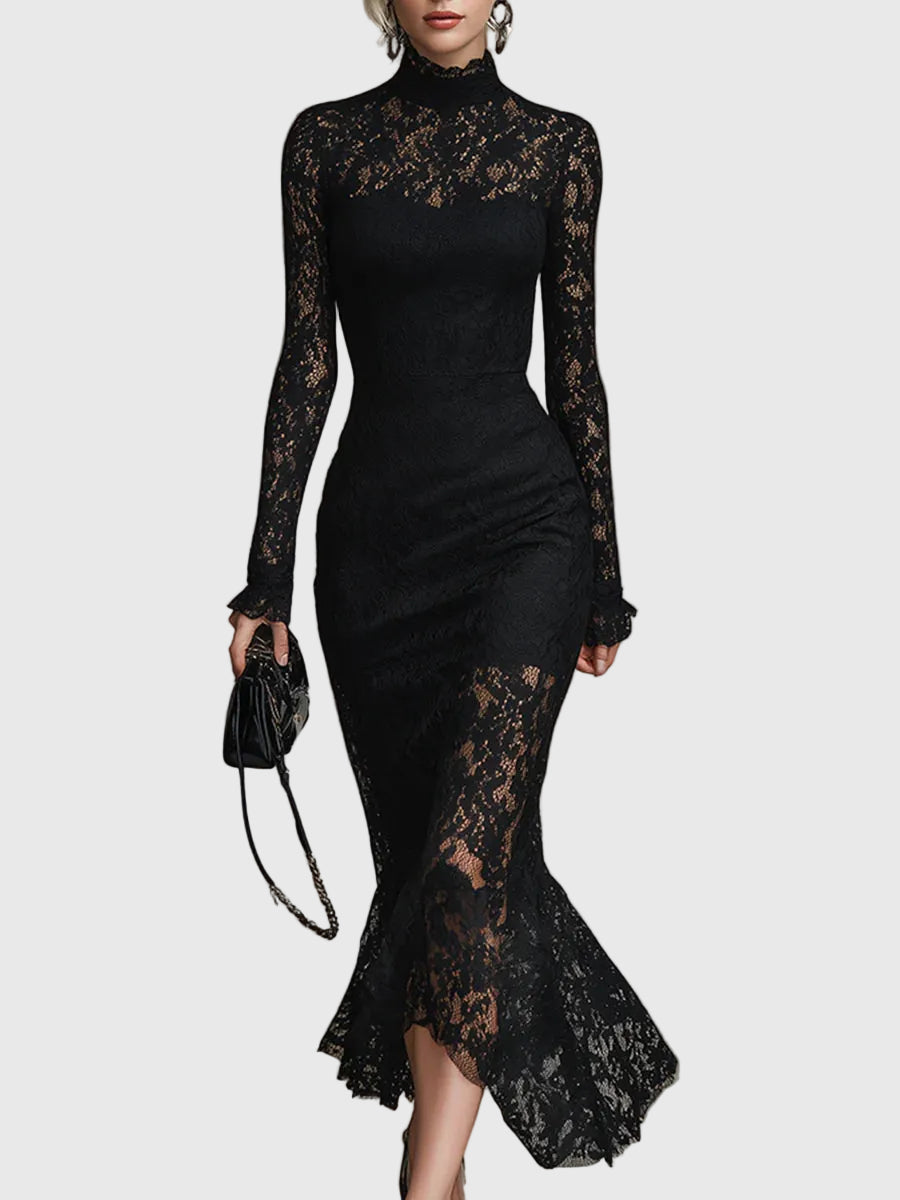 Woman wearing a fitted black maxi dress with a delicately textured skirt that flares out towards the hem.