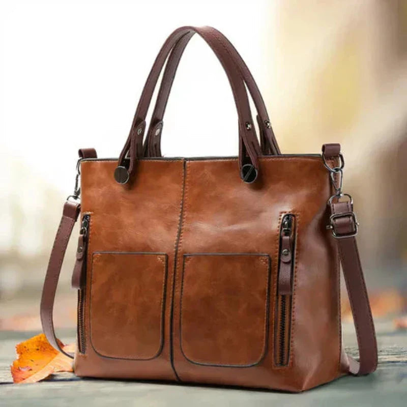 A woman holding a versatile classic handbag with a rich finish by her side