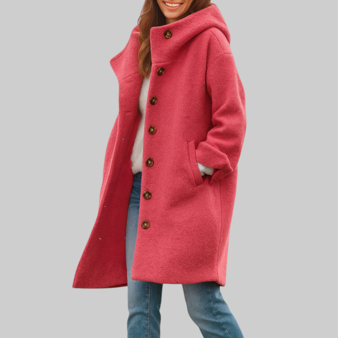 A woman wearing a hooded mid-length coat with wood-look buttons, hands in the side pockets.