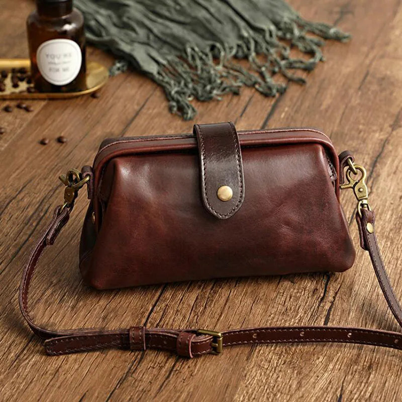 A woman carrying a trendy shoulder bag with a rich finish over one shoulder