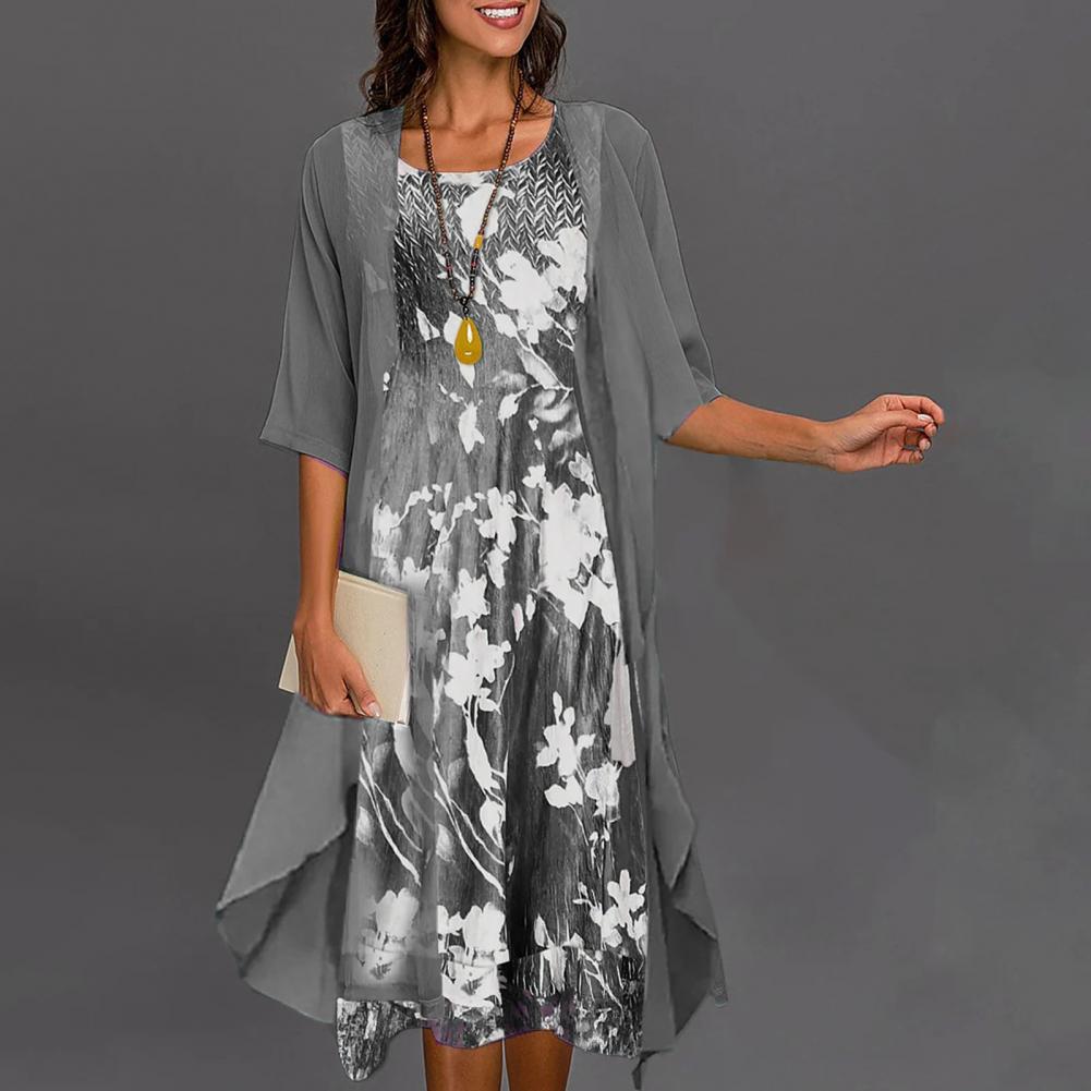 A woman wearing a flowing layered dress set with a printed inner dress, graceful and elegant.