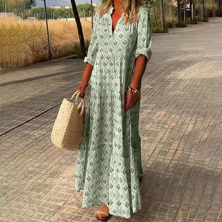 Woman wearing the Monica™ elegant boho maxi dress with a V-neckline and flowing skirt at a summer occasion.