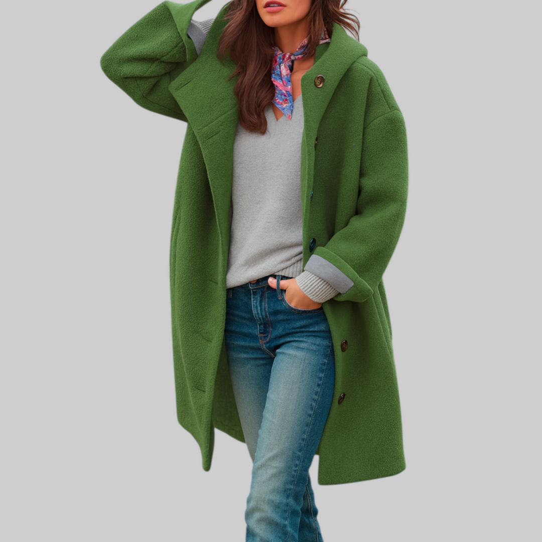 A woman wearing a hooded mid-length coat with wood-look buttons, hands in the side pockets.