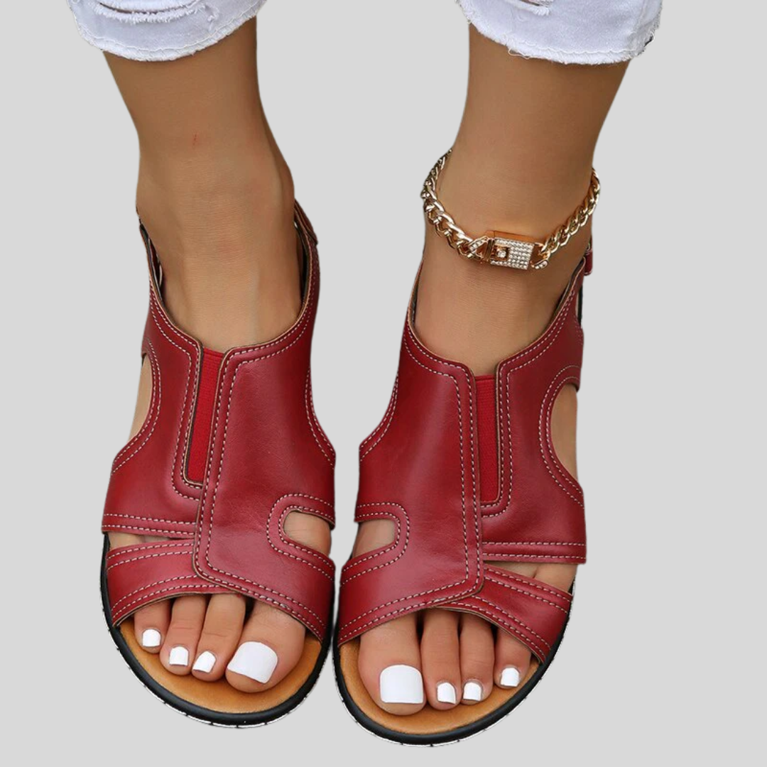 A woman wearing supportive heeled sandals with a summer dress, walking comfortably and looking relaxed.