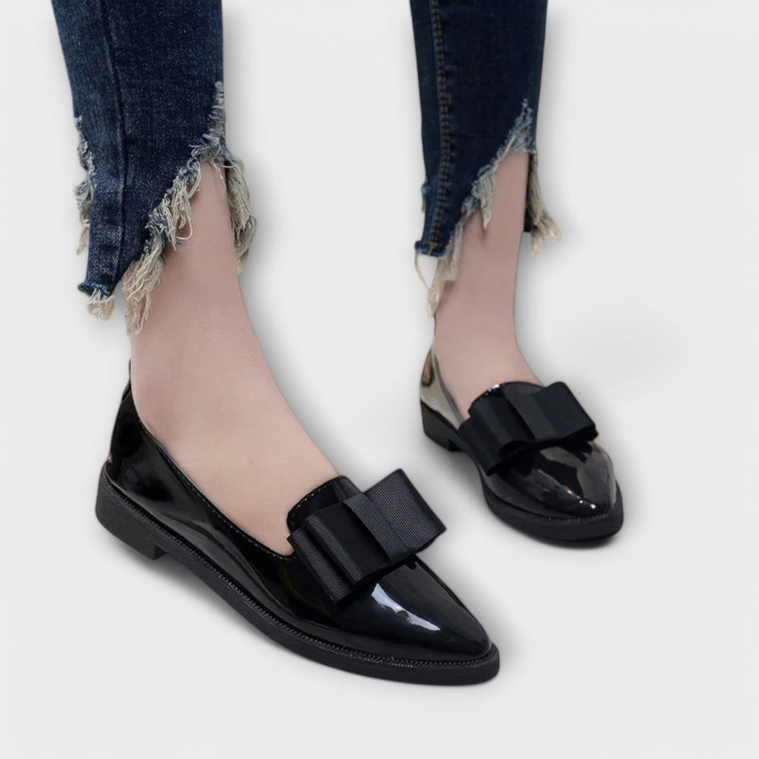 A woman wearing refined classic loafers with a smart everyday outfit