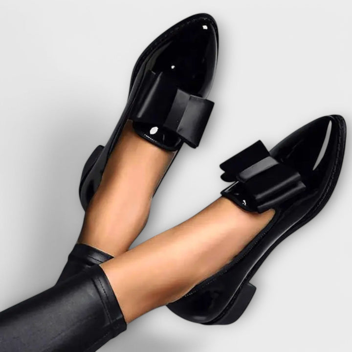 A woman wearing refined classic loafers with a smart everyday outfit