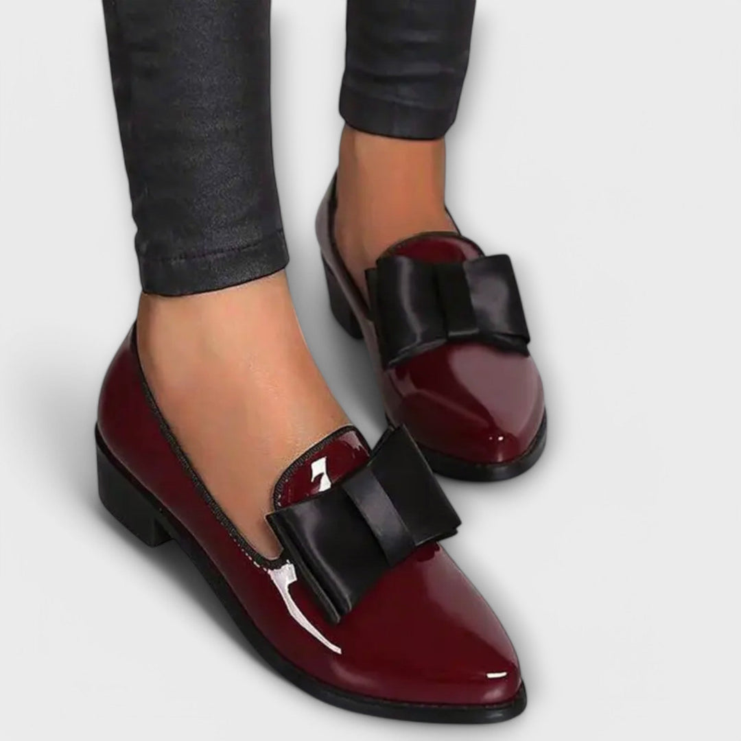A woman wearing refined classic loafers with a smart everyday outfit