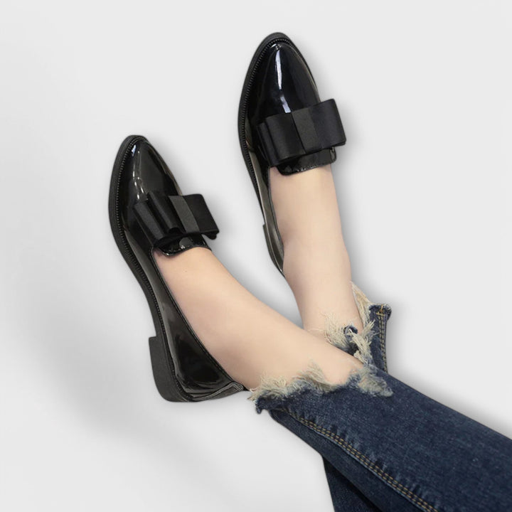 A woman wearing refined classic loafers with a smart everyday outfit