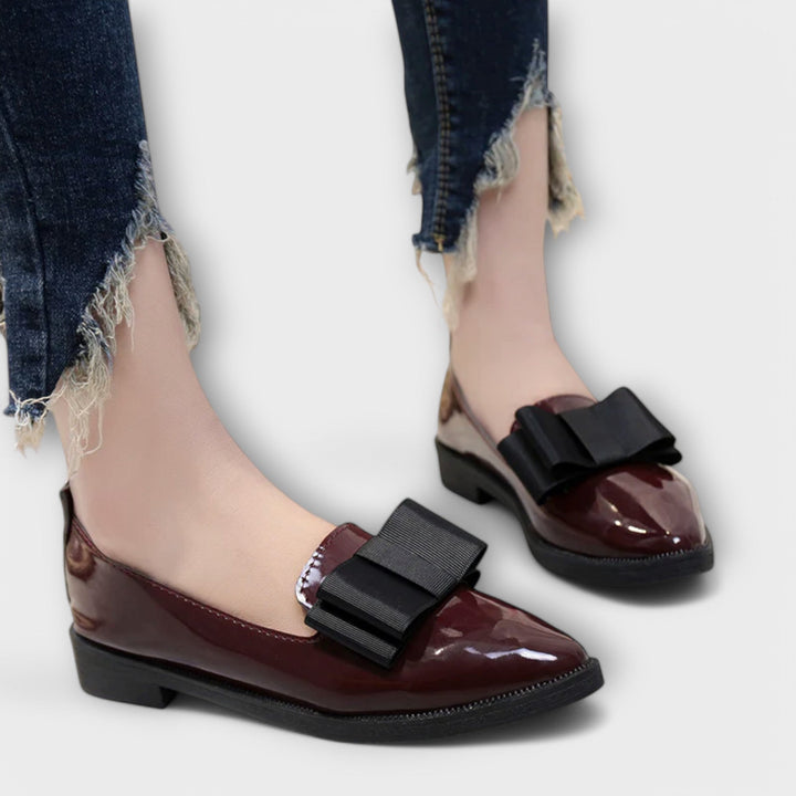 A woman wearing refined classic loafers with a smart everyday outfit