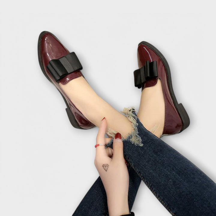A woman wearing refined classic loafers with a smart everyday outfit