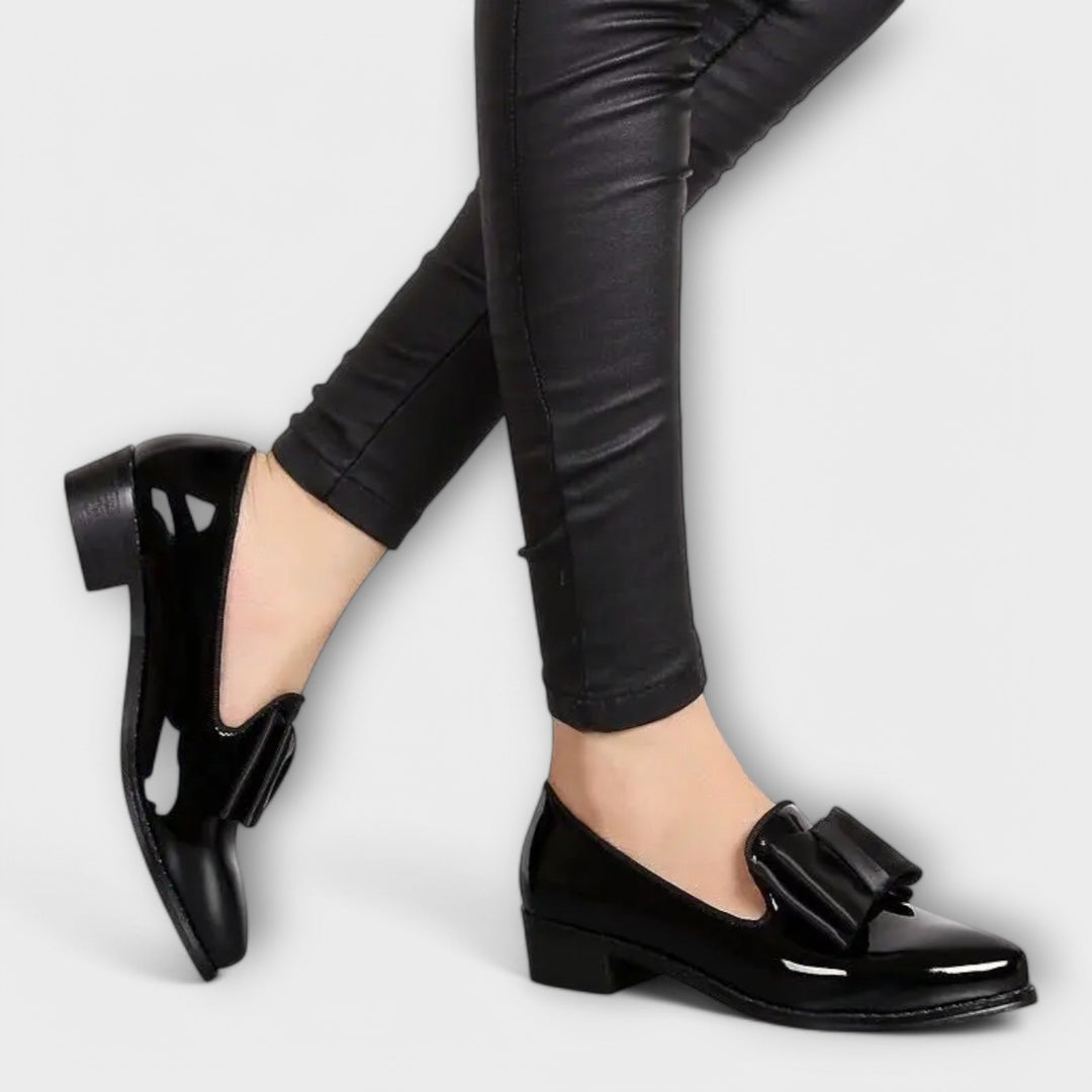 A woman wearing refined classic loafers with a smart everyday outfit