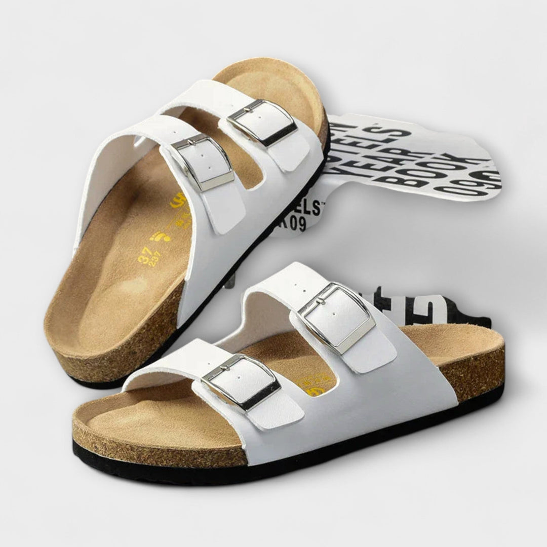 A woman strolling in the sunshine wearing supportive, cushioned everyday comfort sandals.