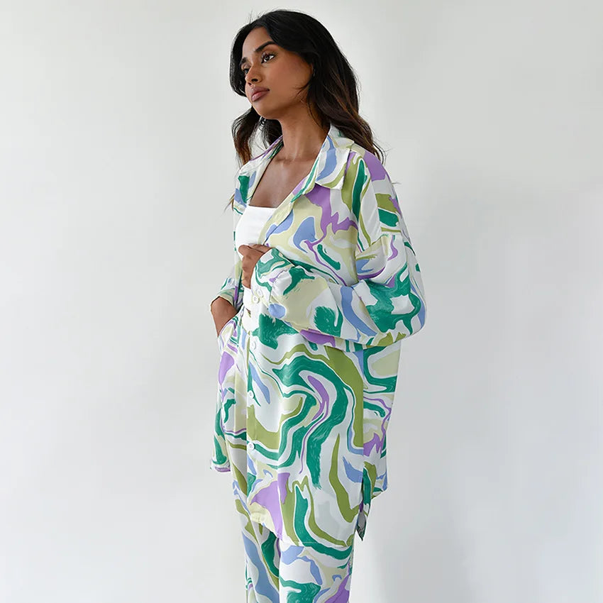 A woman wearing a bold abstract swirl-print shirt and matching wide-leg pants in the city
