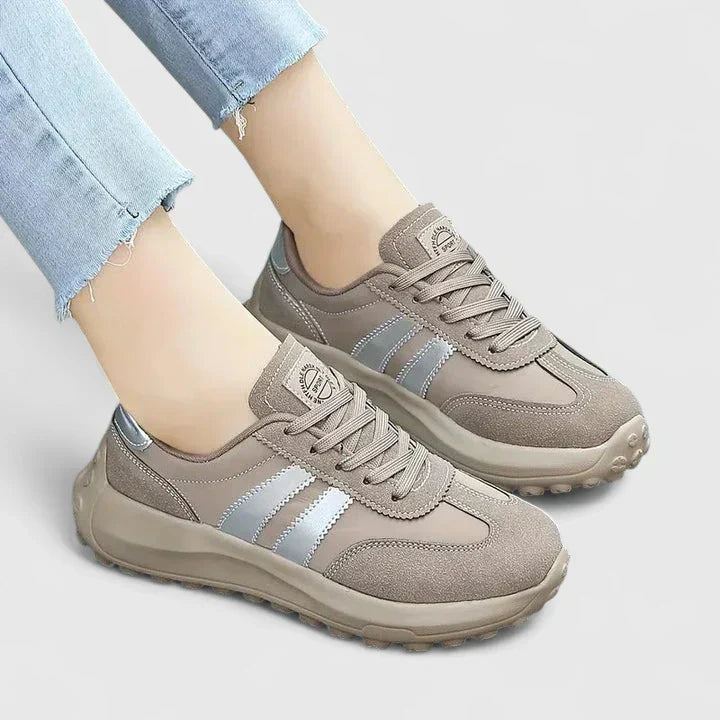 A woman wearing grey orthopaedic sneakers on a city stroll