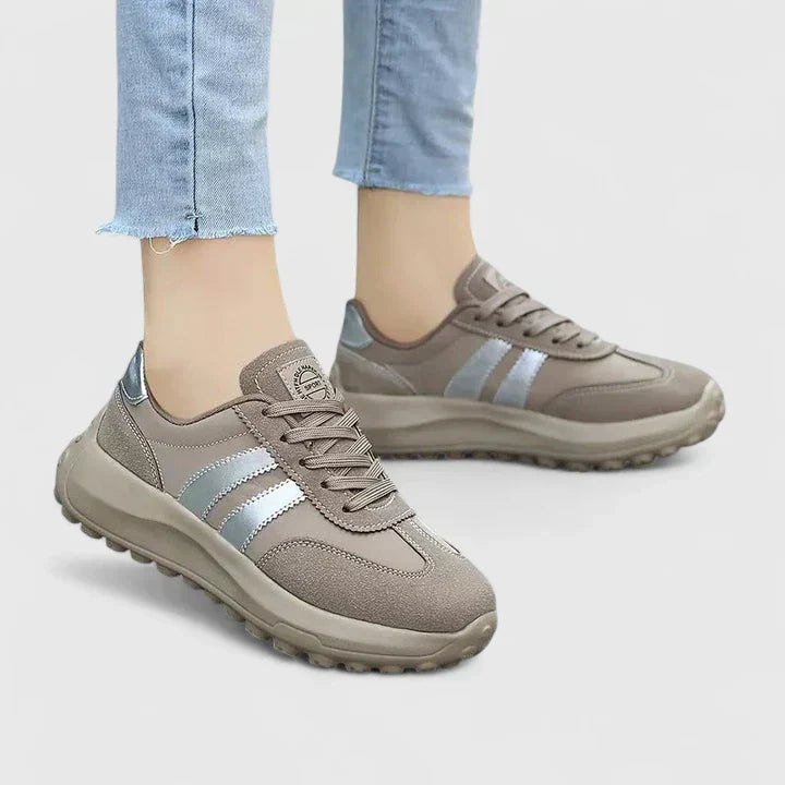 A woman wearing grey orthopaedic sneakers on a city stroll