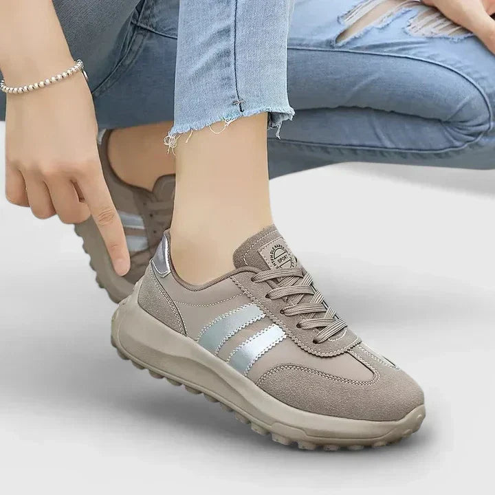 A woman wearing grey orthopaedic sneakers on a city stroll