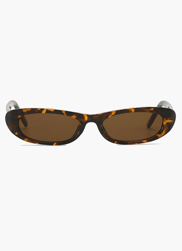A woman wearing retro black oval cat-eye sunglasses on a sunny day.