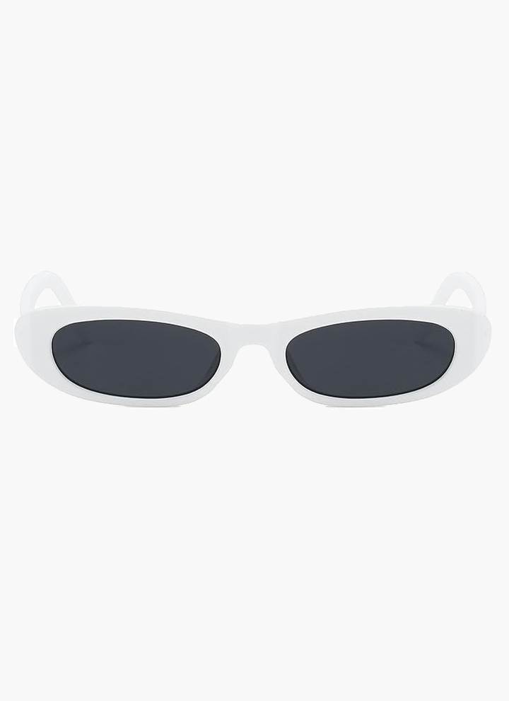 A woman wearing retro black oval cat-eye sunglasses on a sunny day.