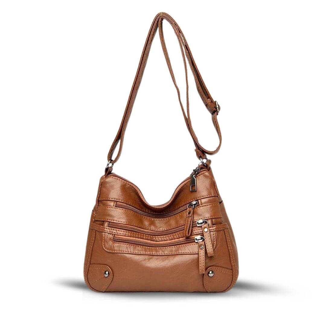 A woman wearing a soft elegant crossbody bag across her body while out shopping.