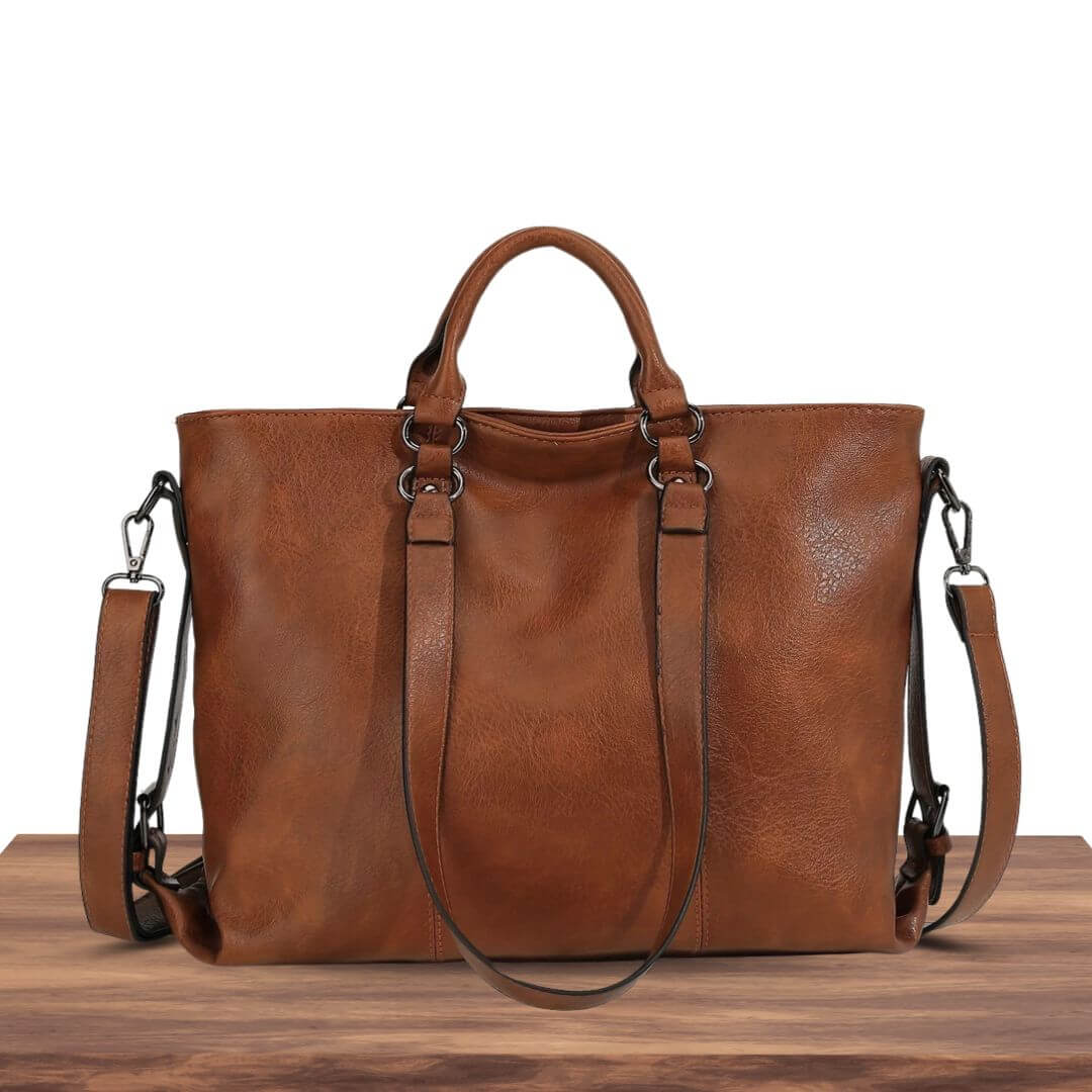 A woman carrying a roomy everyday tote bag on her shoulder while out for coffee in town.