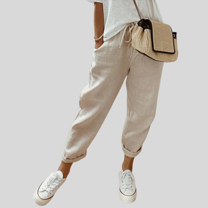 A woman wearing flowing elegant pants with a soft elastic waist and deep pockets.