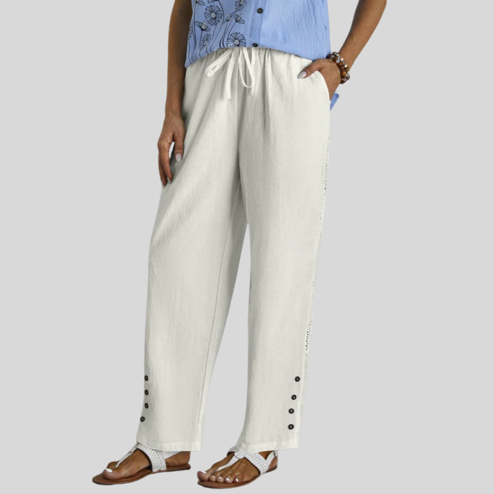 Woman wearing relaxed button-detail pants with a simple top, out for the day.