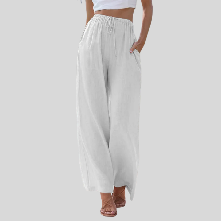 A woman in loose wide-leg summer pants styled with a light top for an easy warm-weather look.
