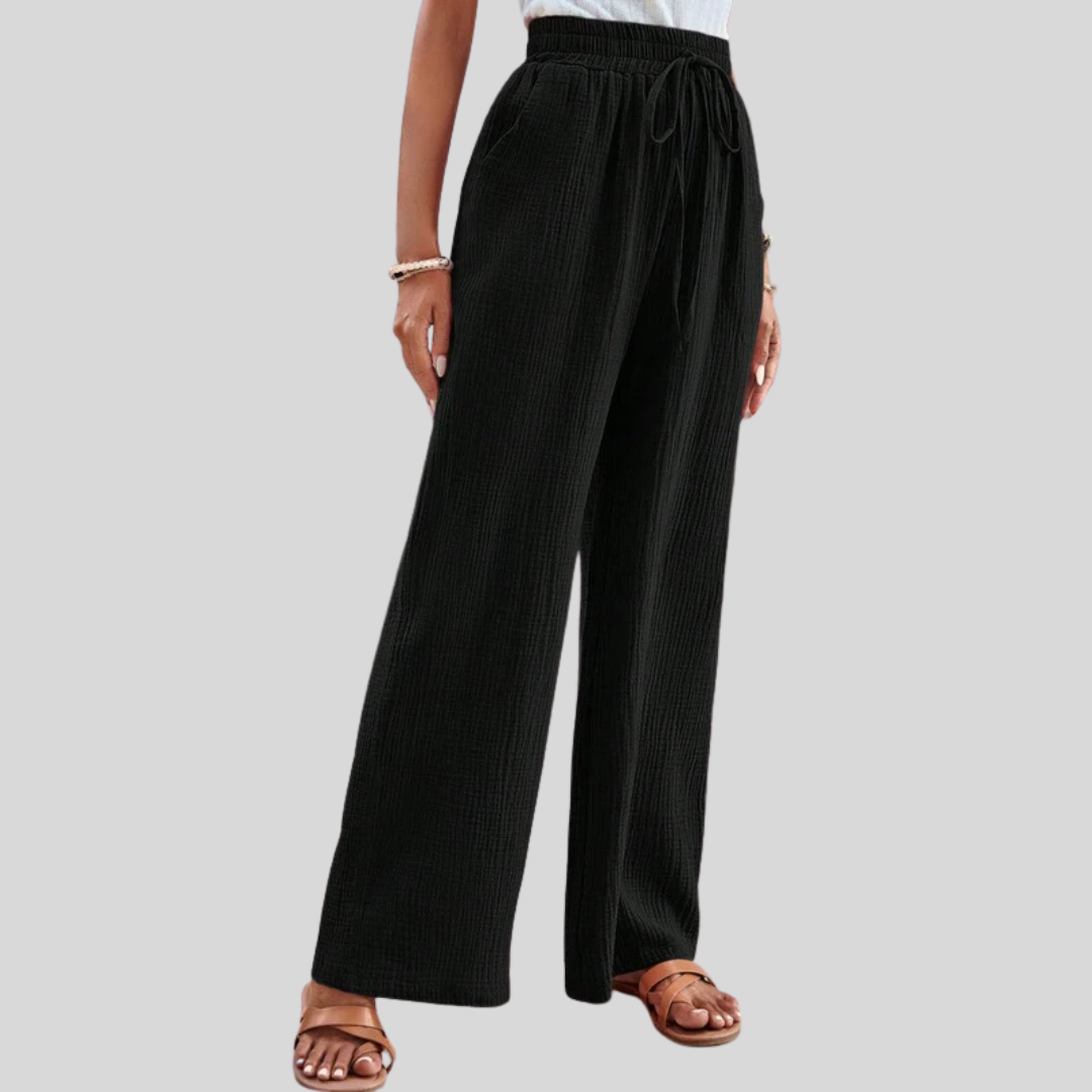 A woman in relaxed wide-leg pants with a drawstring waist, styled for an easy casual look.