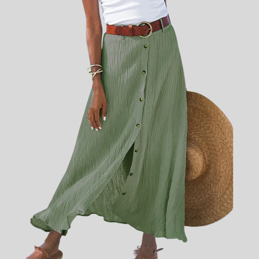 Woman wearing a flowing high-waisted button skirt with a tucked-in top, walking outdoors.