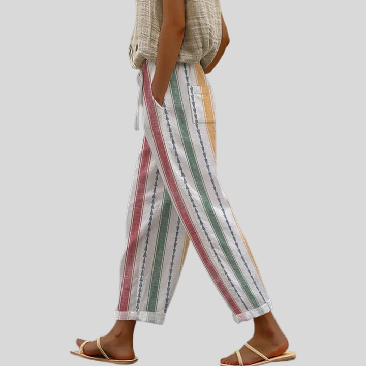 A woman wearing colourful vertical-striped casual pants with a straight leg and elastic waist.
