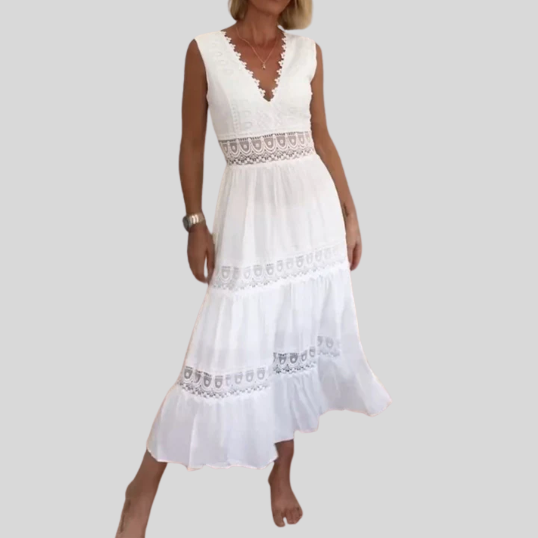 Woman wearing the April™ camisole maxi dress with delicate detailing and a flowing skirt at a summer gathering.