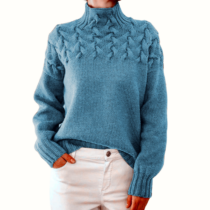A woman wearing a warm roll-neck sweater, cosy and elegant on a cold winter day.