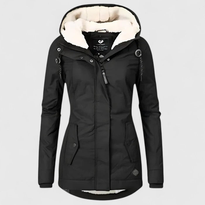 A woman wearing a waterproof hooded jacket outdoors on a wet day