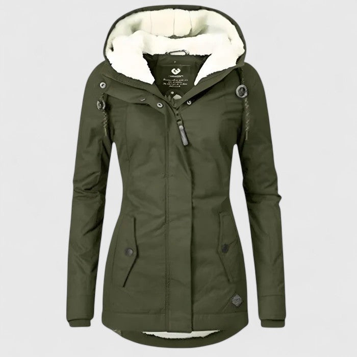 A woman wearing a waterproof hooded jacket outdoors on a wet day