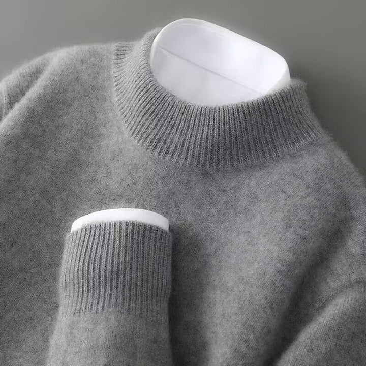 A woman wearing a soft luxe crew neck sweater with a matte finish, styled with smart pants.