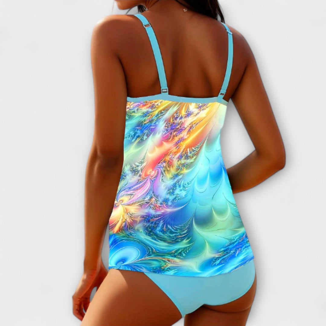 A woman at the beach in a coordinated printed tankini set, relaxed and confident in the sun.