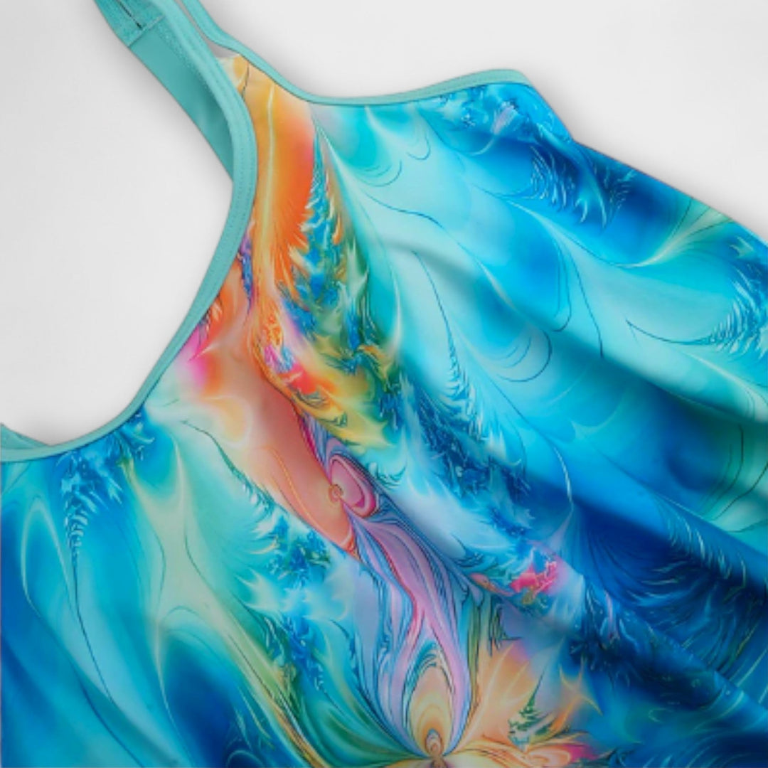 A woman at the beach in a coordinated printed tankini set, relaxed and confident in the sun.