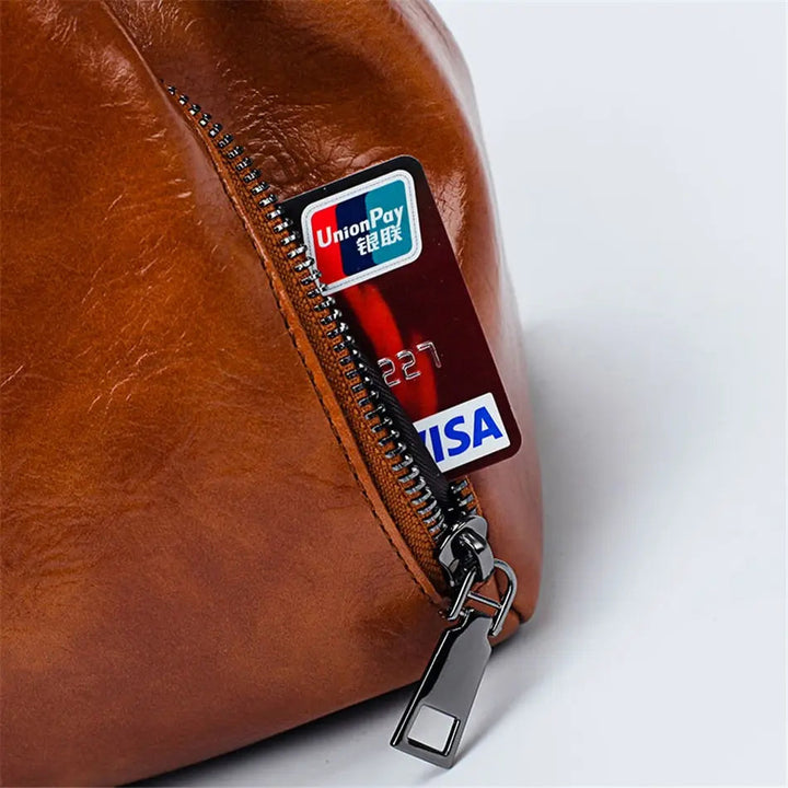 A woman carrying a versatile structured handbag on her shoulder while out in town.