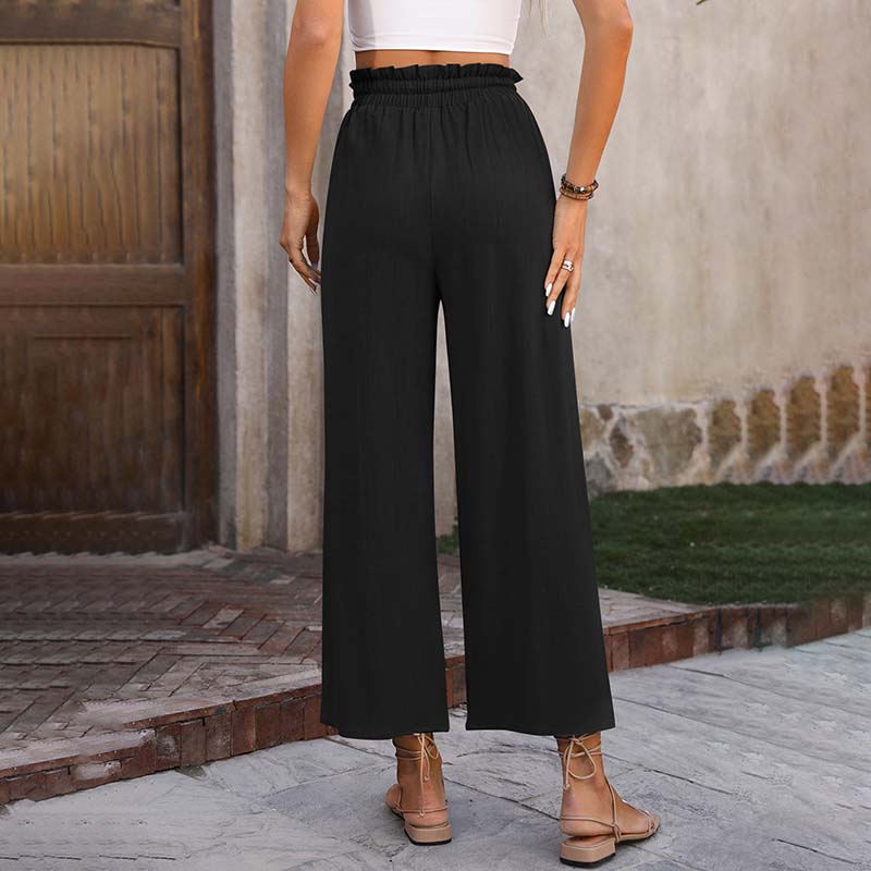 A woman in light cropped wide-leg pants styled with sandals for a relaxed summer look.