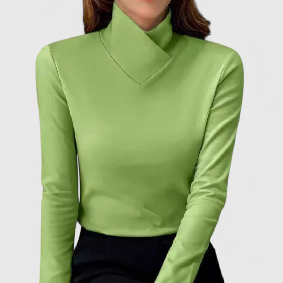 A woman wearing an elegant stand-collar sweater, slim and refined with a flattering line.