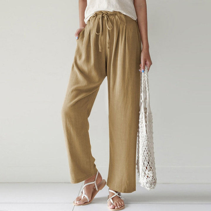 A woman walking outdoors in relaxed drawstring pants with an easy, comfortable everyday look.