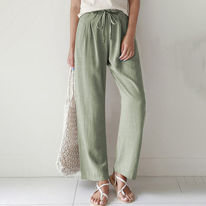 A woman walking outdoors in relaxed drawstring pants with an easy, comfortable everyday look.