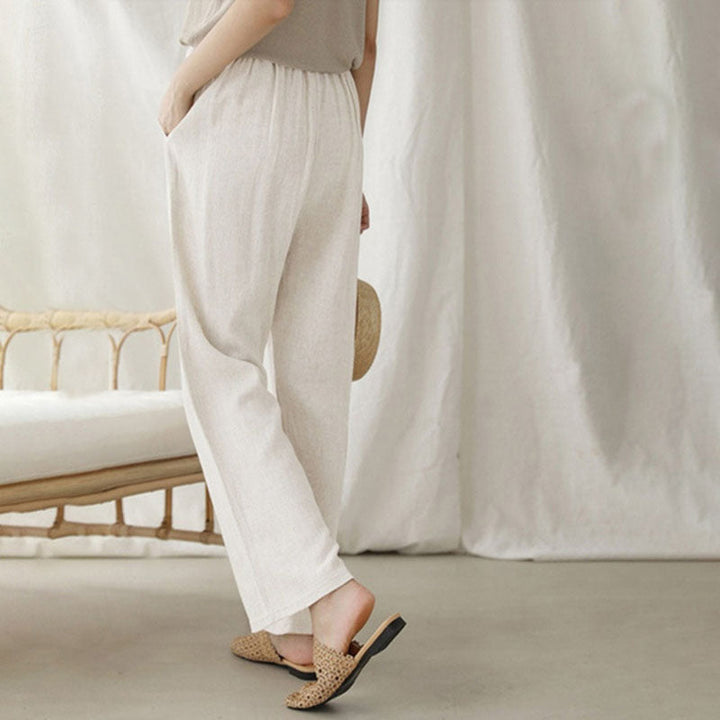 A woman walking outdoors in relaxed drawstring pants with an easy, comfortable everyday look.