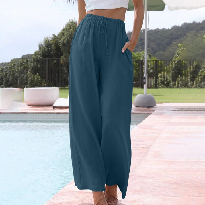 A woman in loose wide-leg summer pants styled with a light top for an easy warm-weather look.