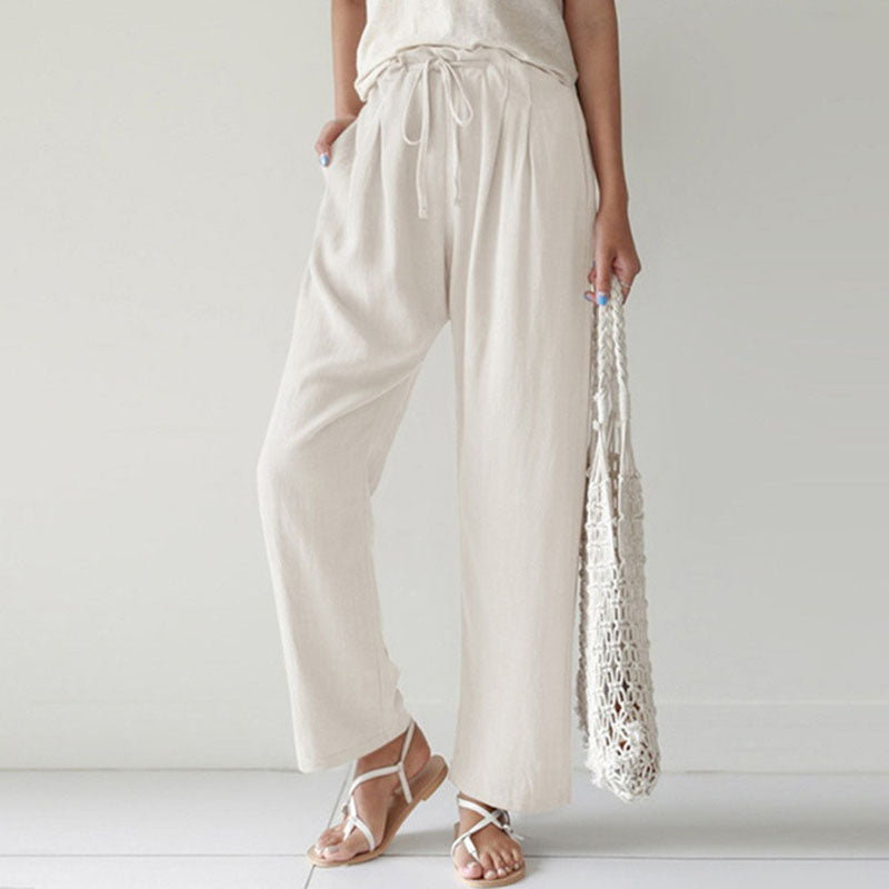 A woman walking outdoors in relaxed drawstring pants with an easy, comfortable everyday look.